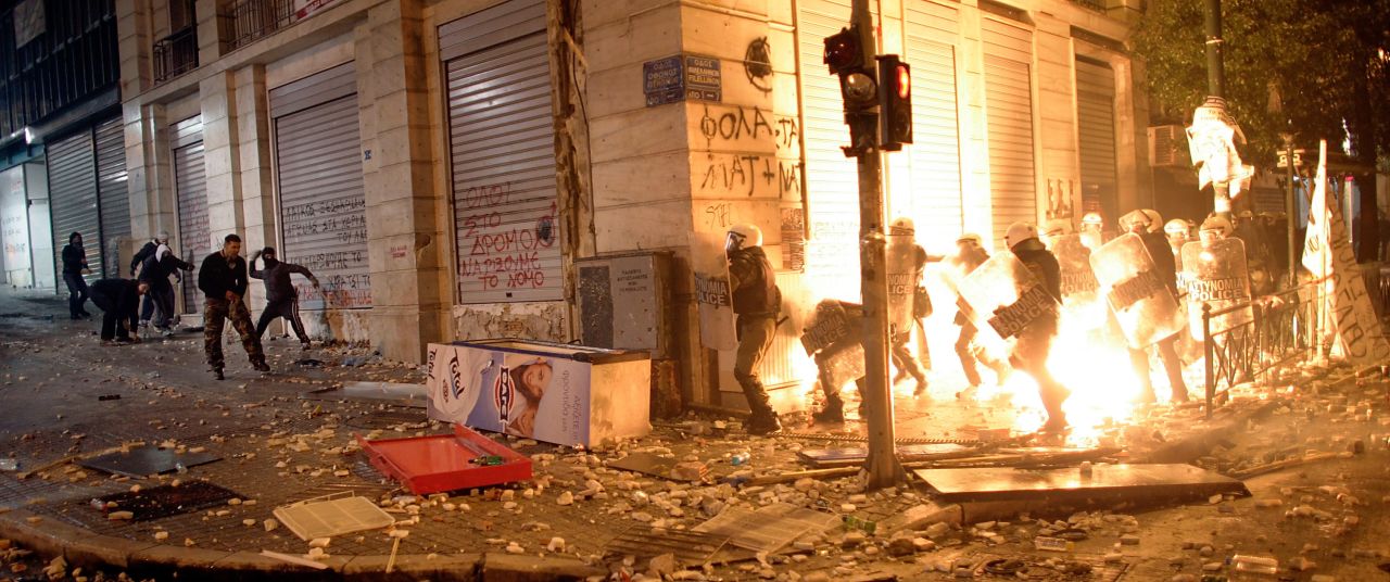 Demonstrators throw fire bombs to riot police during violent protests in central Athens. Twenty-five protesters and 40 officers were injured in the clashes, which occurred throughout the city, police said.