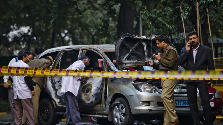 Police and forensic officers examine a damaged Israeli embassy vehicle after an explosion, on February 13, 2012 in New Delhi, India