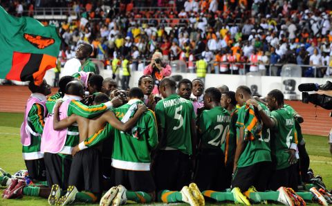 The Zambia team gather together in prayer moments after Stoppila Sunzu's penalty earned the Copper Bullets' first African title.
