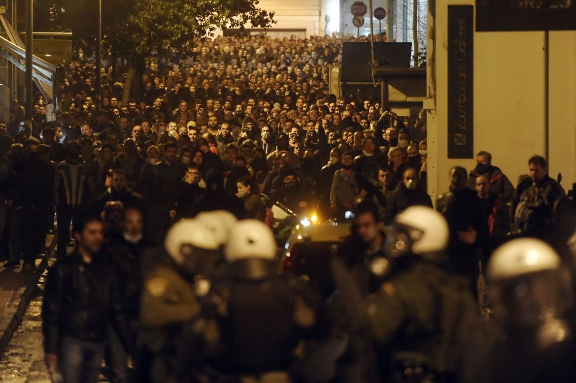 Protesters clash with riot police near the Greek parliament in Athens on February 12, 2012.