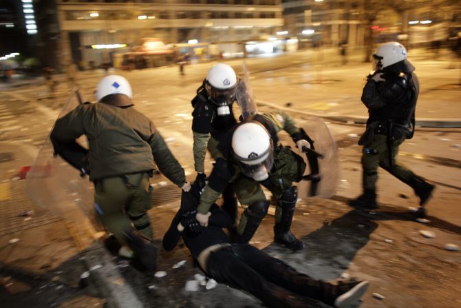 Police arrest a protestor in the streets during a demonstration against austerity measures on February 12, 2012 in Athens.