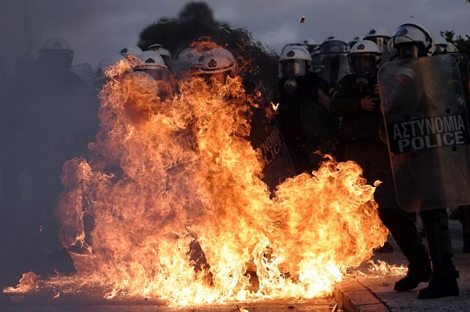 A riot police is engulfed by flames during clashes with protestors in Athens on February 12. Greek police used tear gas on petrol bomb-throwing protesters outside parliament where lawmakers were debating a new austerity plan aimed at staving off bankruptcy.