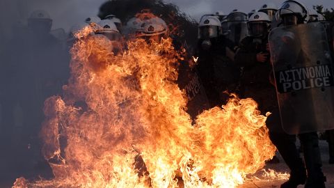 Riot police are engulfed by flames during clashes with protestors in Athens on February 12, 2012. 