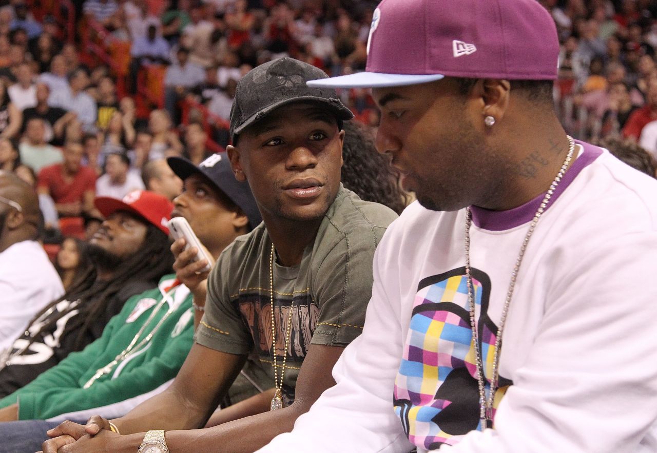 Boxer Floyd Mayweather, pictured center at an NBA game, <a href="http://edition.cnn.com/2012/02/14/sport/sport-nba-lin-knicks/index.html">criticized the hype surrounding Lin</a>. He said the attention was based on Lin's ethnic background, rather than his ability.