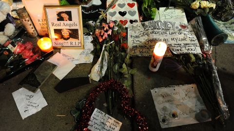 Whitney Houston fans share their feelings at a remembrance outside the Beverly Hilton Hotel in Los Angeles on Monday. 