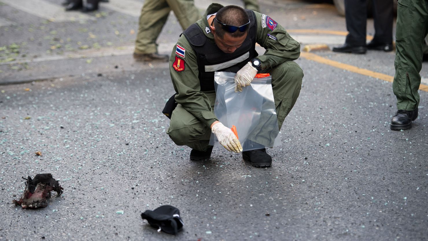 Thai bomb squad officials inspect the site of an explosion in Bangkok on February 14, 2012.