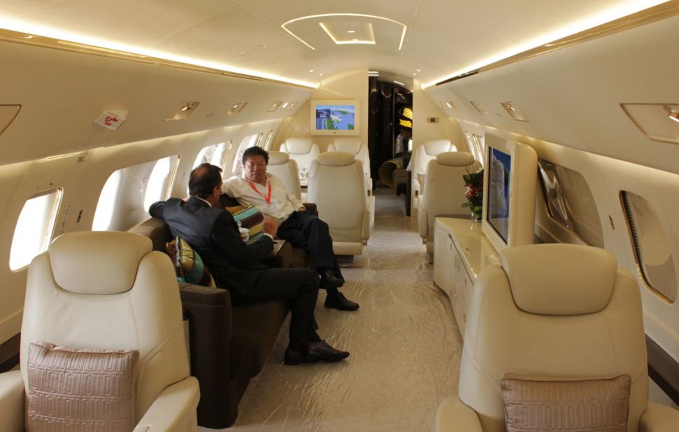 A potential client enjoys the upholstery on board the Embraer Lineage 1000. 