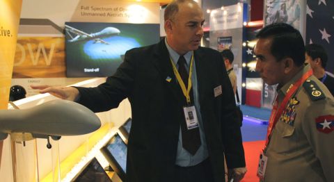 The not so hard sell: A representative from Israeli defence company Elbit Systems introduces its collection of UAVs to a Singaporean military officer.