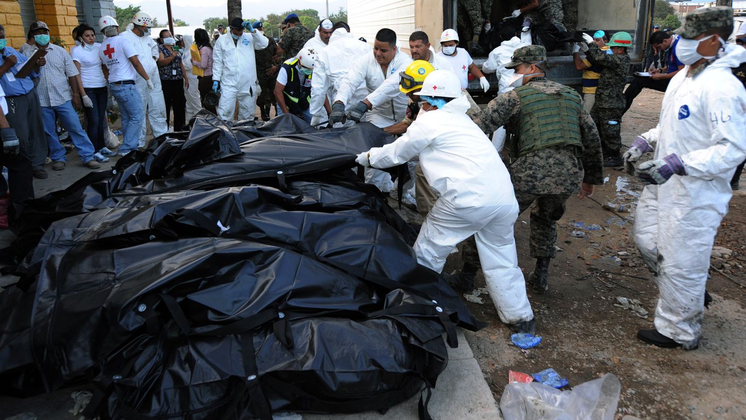 Honduran forensic workers and soldiers remove corpses in plastic bags from the National Prison in Comayagua on Wednesday. 