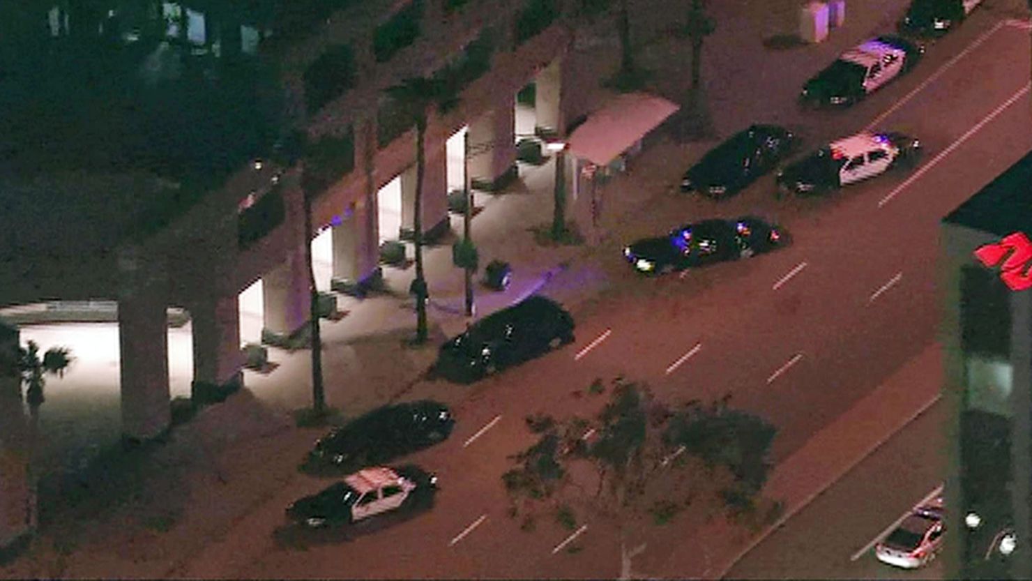 Police cars sit outside the ICE offices in Long Beach, California, after a shooting on Thursday.