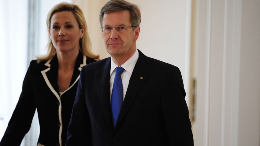 Germany's president Christian Wulff (R) and his wife arrive for a statement to announce he resignation.