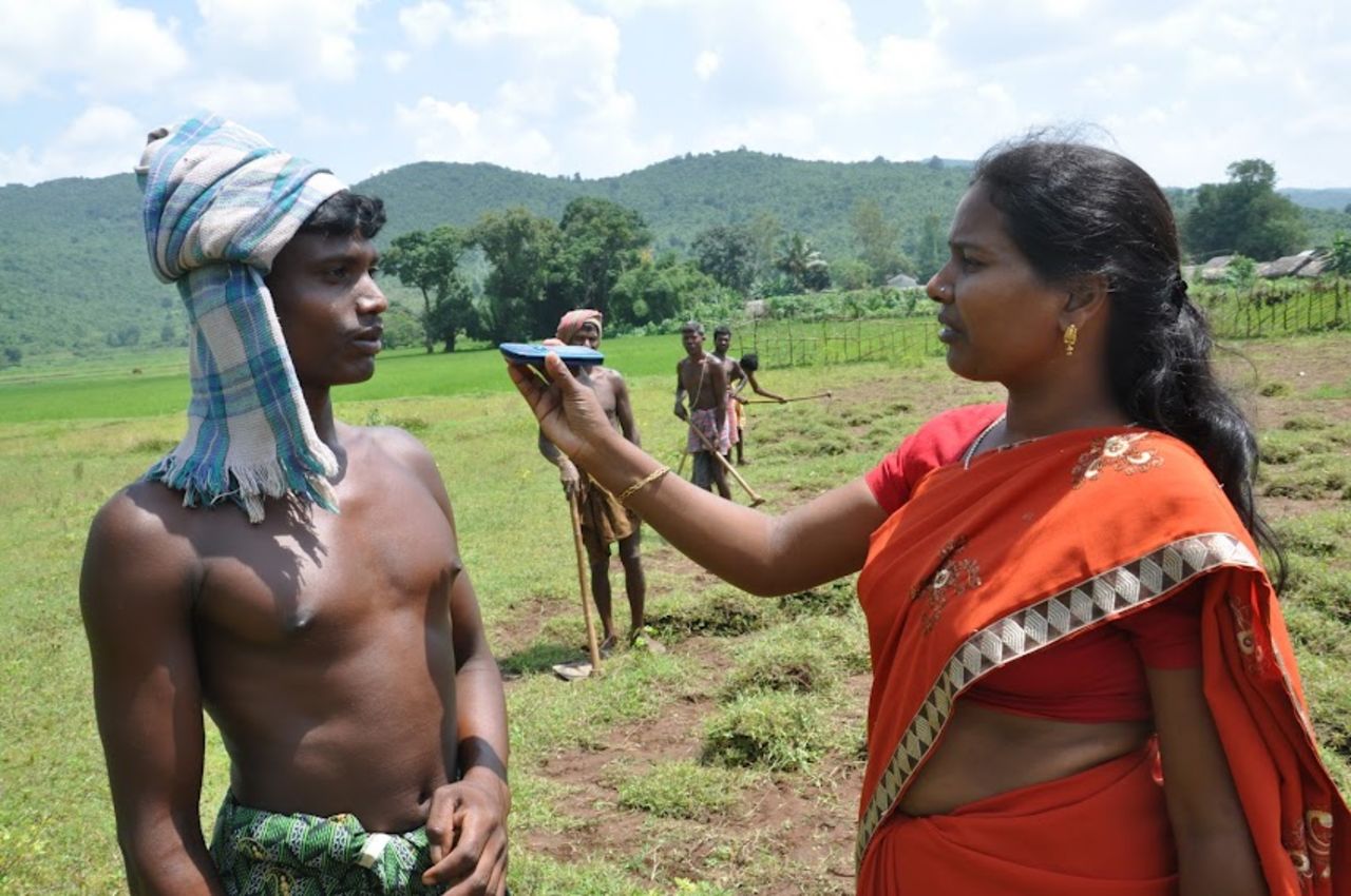A citizen journalist conducts an interview using her mobile phone in Chhattisgarh state, India.