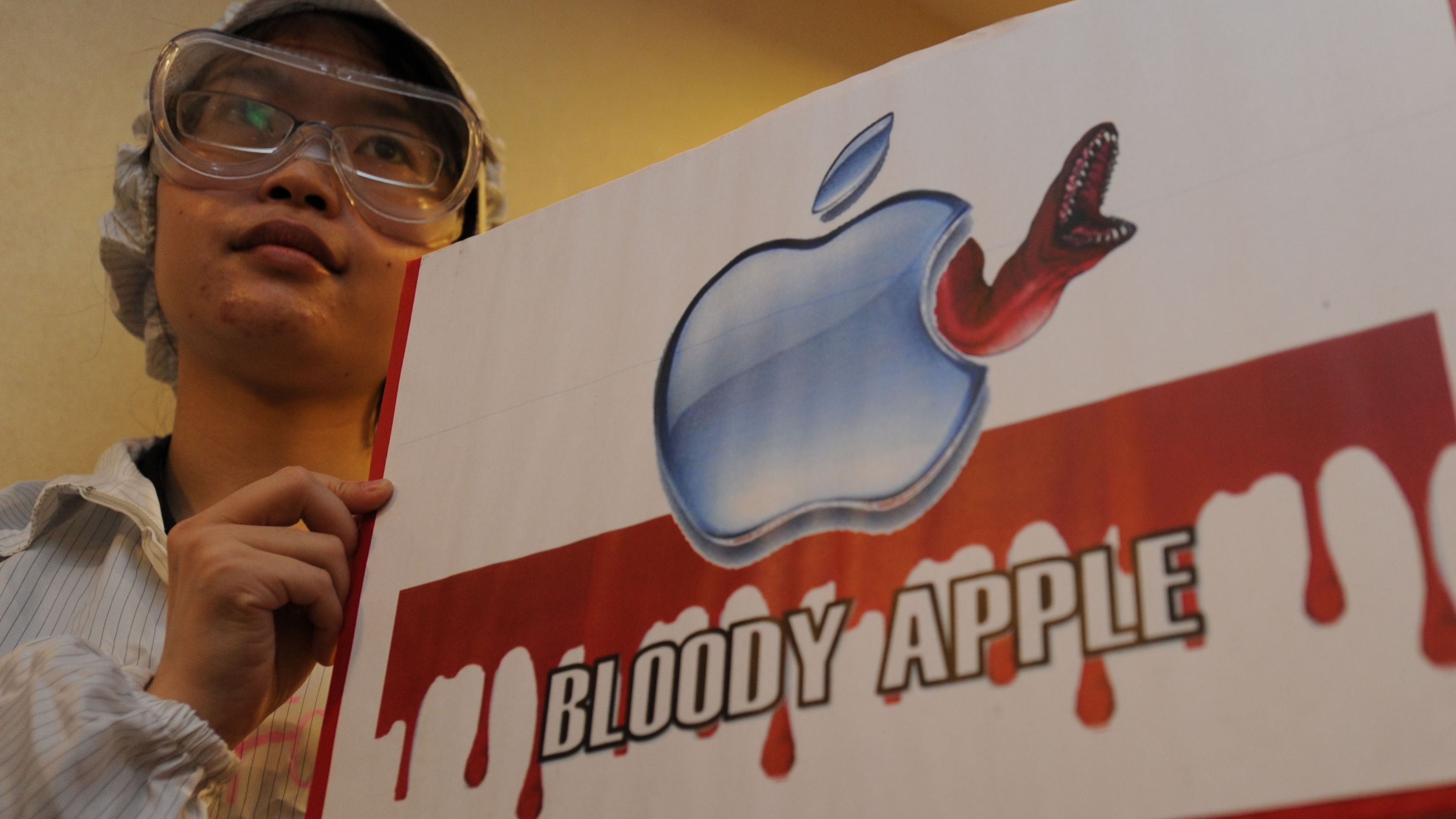 A protester takes part in a rally last year in Hong Kong against Foxconn, which makes Apple products.