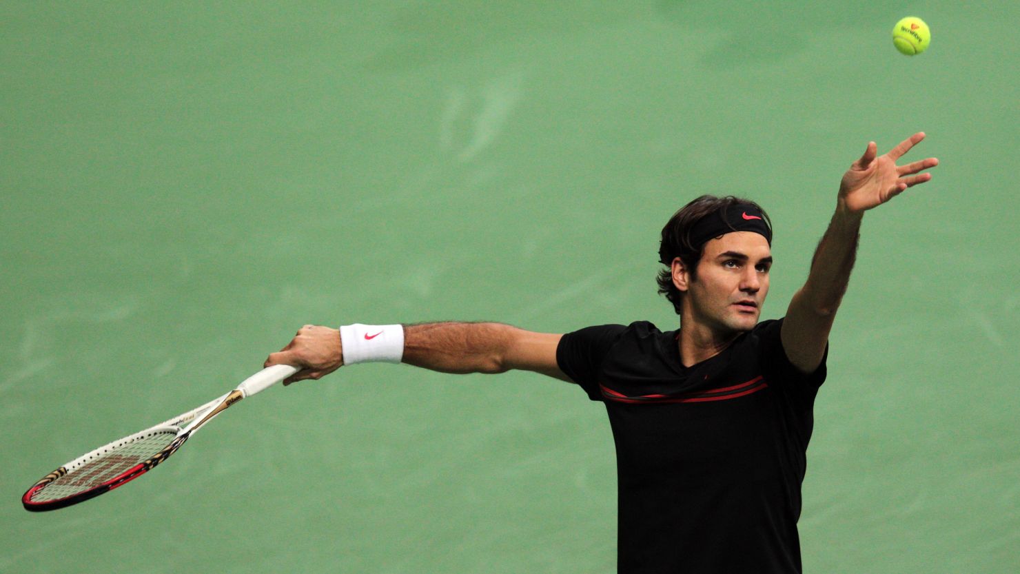 Roger Federer serving during his semifinal meeting with Russia's Nikolay Davydenko in Rotterdam on Saturday