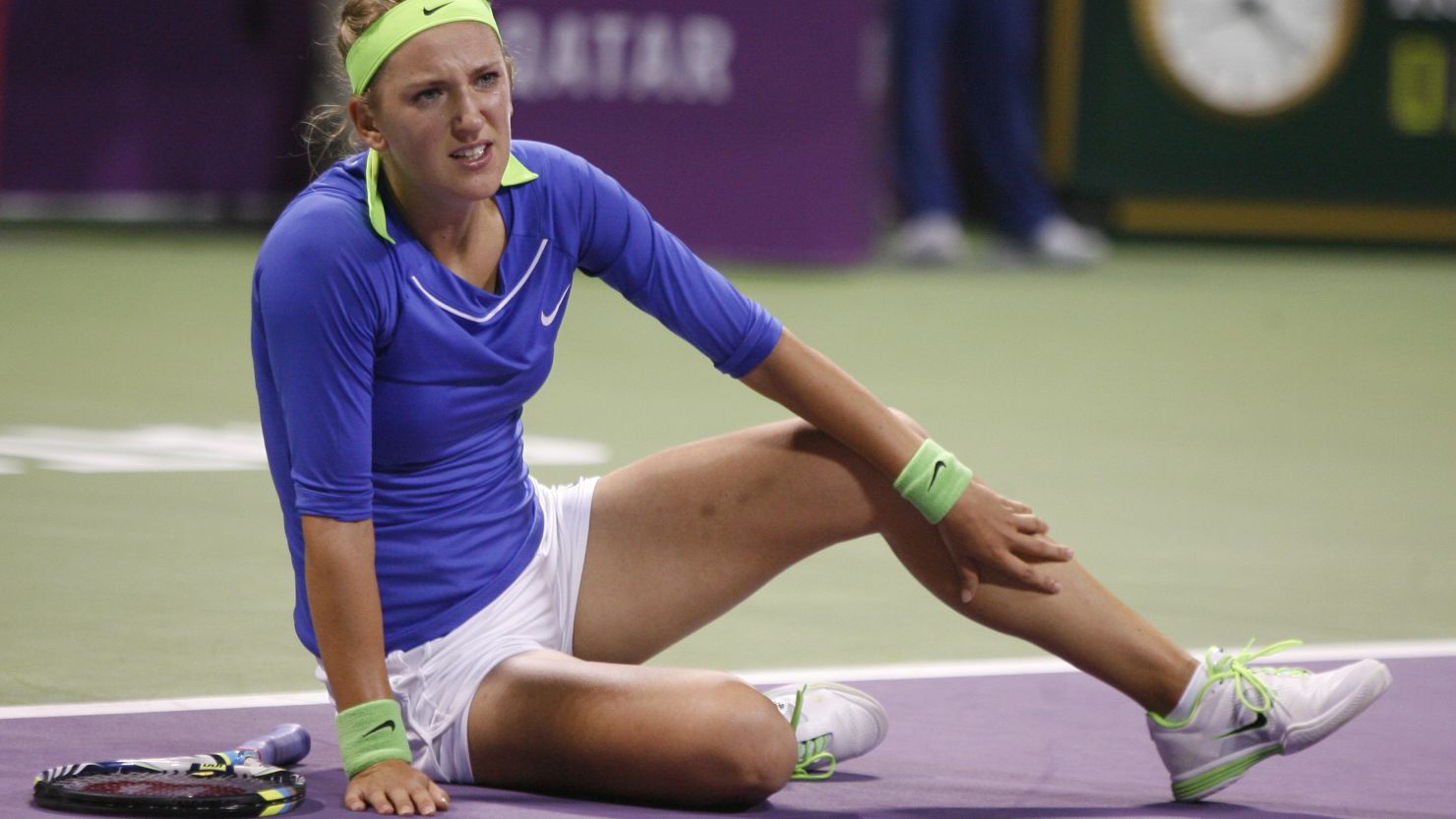 Down but not out: Victoria Azarenka clutches her ankle during her straight sets win over Aginezska Radwanska