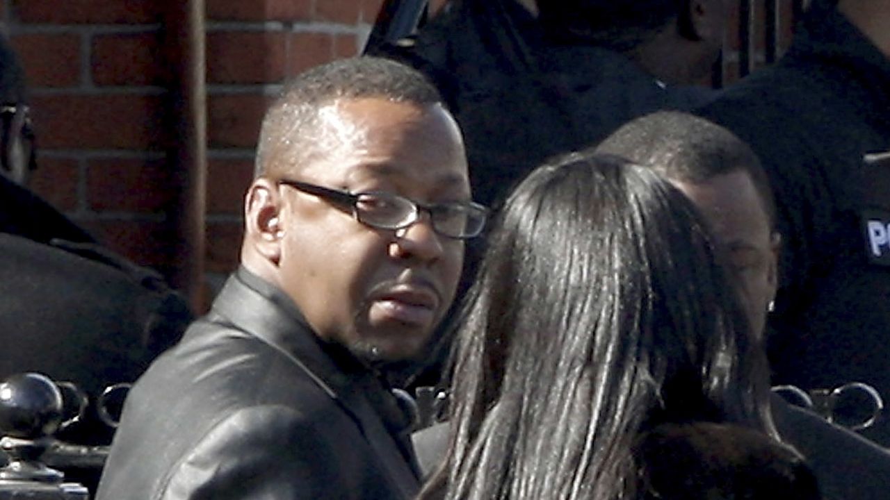 Bobby Brown, left, outside the funeral of his ex-wife, Whitney Houston. Brown later left abruptly.