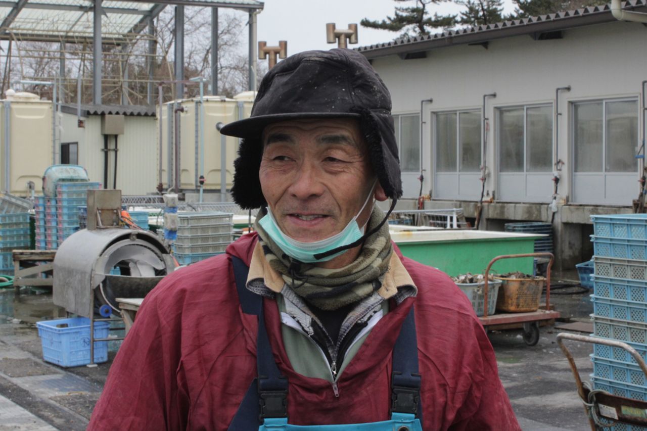 A worker at the oyster processing plant on Katsurashima says that more fishermen are having to pool resources.