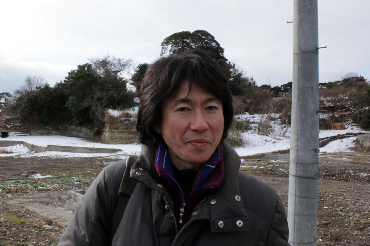 Standing in front of where his home used to be, Yoshimasa Koizumi says he has created a new form of cooperative he hopes will revive fishing and create a sustainable industry for the islanders.