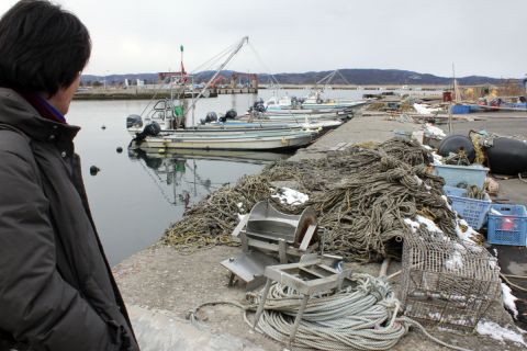 Yoshimasa Koizumi looks at his fishing equipment on Katsurashima Island. He has never used it, having moved to the island one day before last year's deadly tsunami.