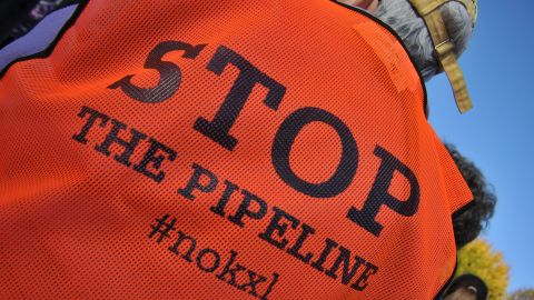 One of thousands of Keystone XL pipeline protesters gathered in Lafayette Park in Washington last year listens to speakers.
