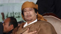 Libyan leader Moamer Kadhafi gestures at supporters in Tripoli on February 13, 2011.