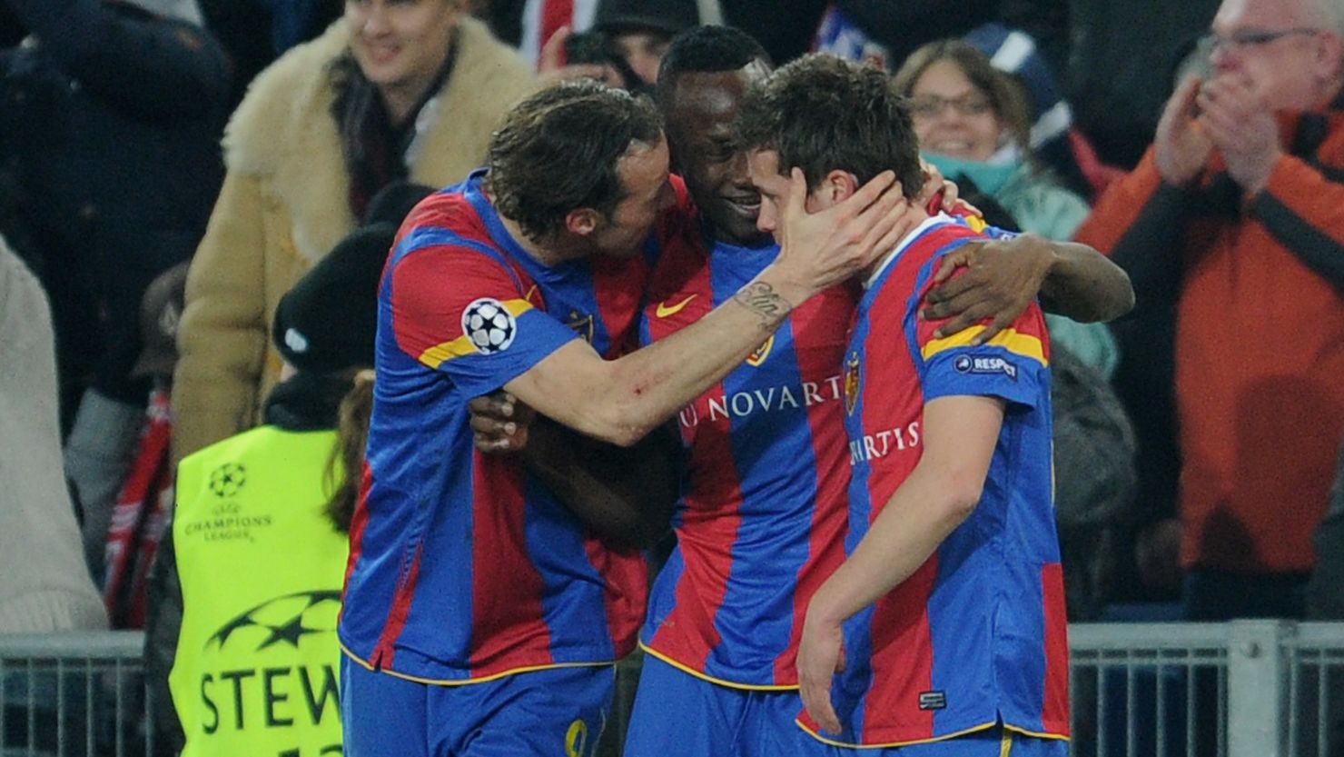 Basel players mob Valentin Stocker after he scored the only goal of the match against Bayern Munich