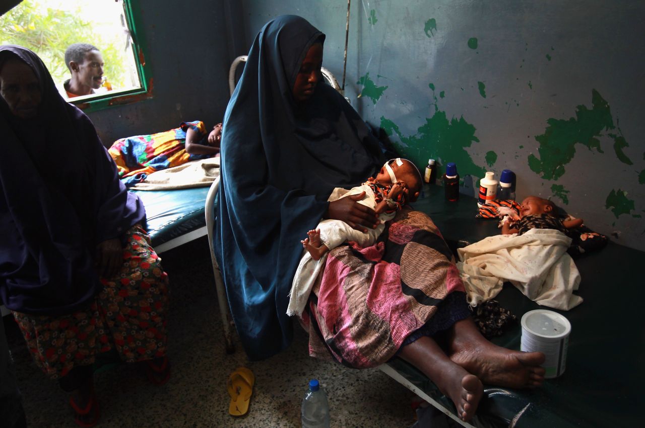 Amid the violence, the Somali people have endured bouts of natural disasters, including famine, drought and floods. In this picture, Farhiyo Hassan sits with her sick and malnourished two month-old twins at the Banadir hospital in Mogadishu, in August 2011. The U.S. government said 30,000 children had died in Somalia due to famine in the previous three months alone.