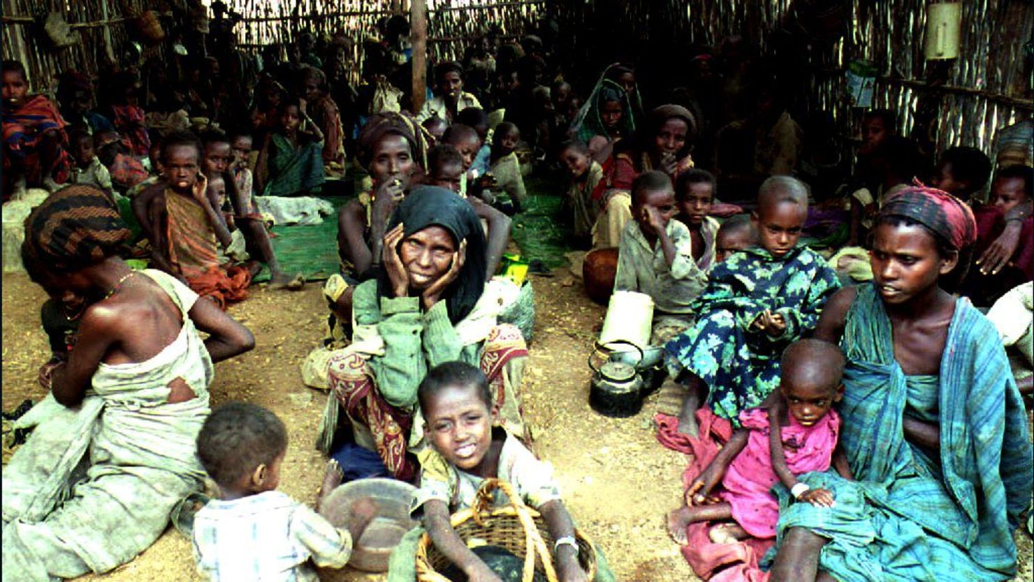 Women and children sit inside a shelter  August 6, 1992 at a feeding center run by the International Committee for the Red Cross (ICRC) in Baidoha, Somalia. The shelter was established to feed a few thousand of the 30,000 refugees suffering from famine, severe drought and the effects of 18 months of civil war. 