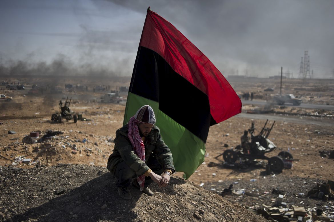 He won first prize in the World Press Photo competition's news category for this image of a Libyan opposition fighter resting under a rebellion flag in the middle of Ras Lanouf.