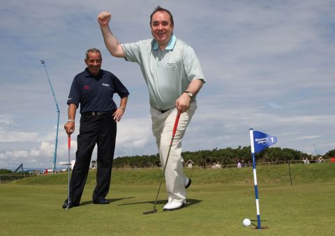Scoltand's political leader  Alex Salmond is a keen golf fan but his government faces a difficult decision over the offshore wind farm as Trump threatens to pull his investment.