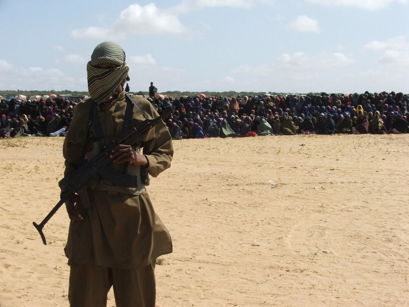An Islamist fighter stands guard as hundreds of residents watch an amputation punishment carried out. Al-Shabaab's implementation of strict Sharia law has begun to alienate many in the way that al Qaeda did in Iraq. Women have been stoned to death for adultery; amputations and beheadings are common. In some areas Al-Shabaab has banned listening to the radio and non-Arabic signs; and it has assassinated several journalists.