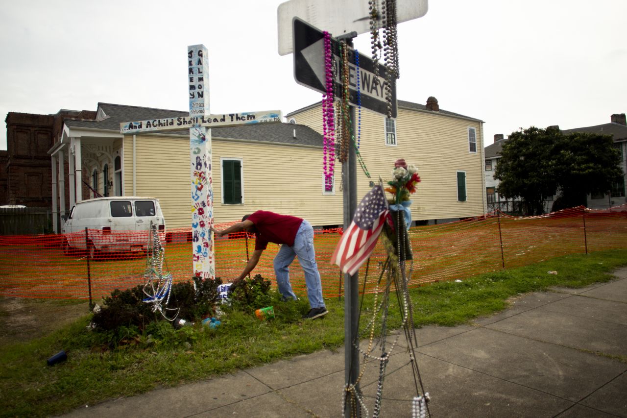 Reminders of death can be found across the area as people honor their loved ones. Fredric Sweetwyne celebrates the life of Jeremy Galmon with a commemorative cross in the Central City neighborhood.