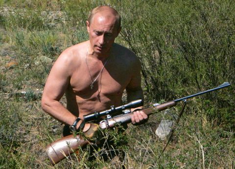 Putin carries a hunting rifle in the Republic of Tuva on September 3, 2007.