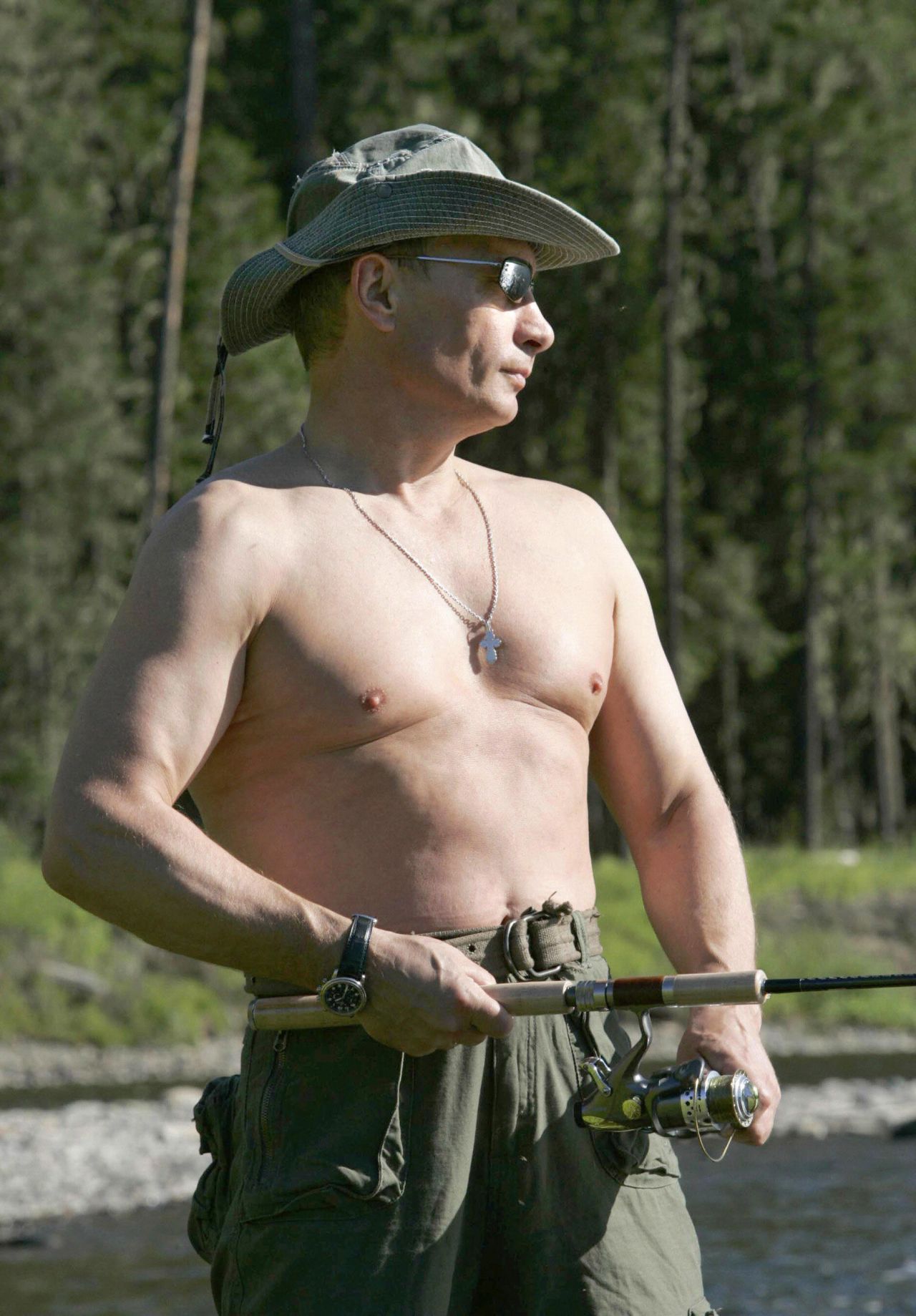 A shirtless Putin fishing in the headwaters of the Yenisei River in the Republic of Tuva on August 13, 2007.