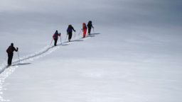 Skiers seek refuge from crowded ski resorts in the relative quiet of backcountry skiing. Here, skiers climb above the treeline on the east ridge of Galena Mountain near Leadville, Colorado.