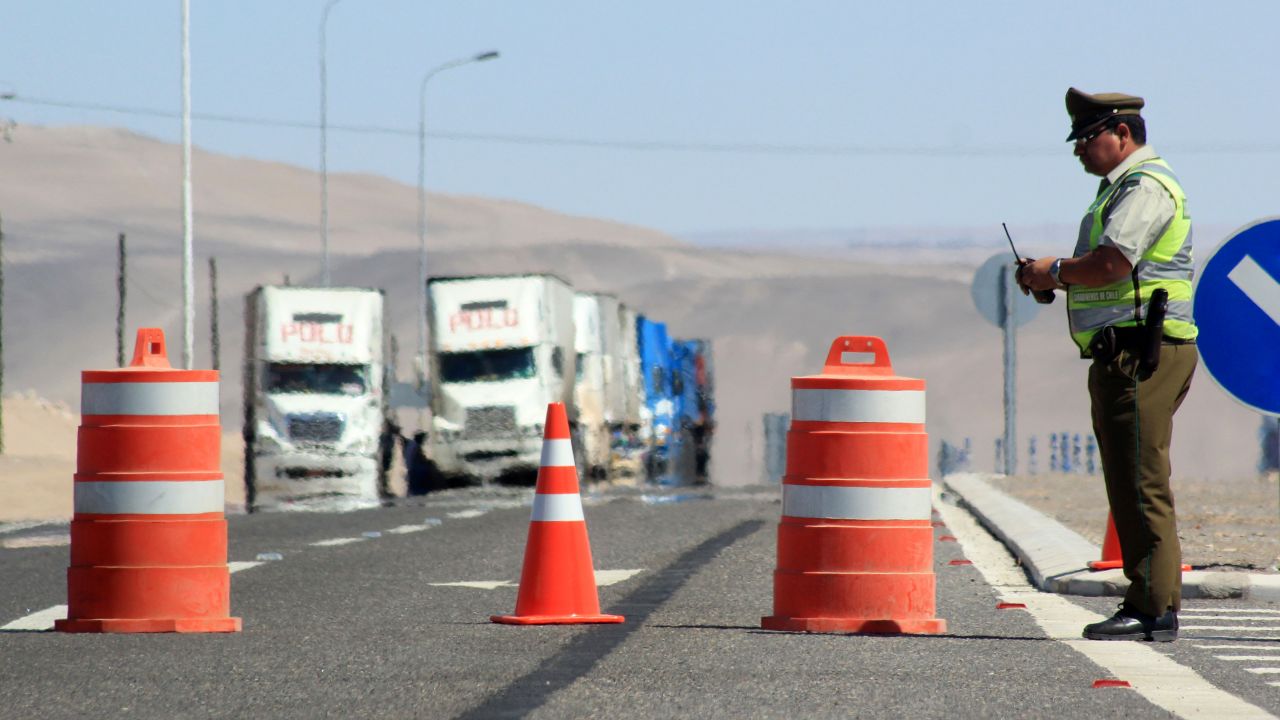 Police stop traffic at the Chile-Peru border after rain washed landmines onto the highway, February 21, 2012.