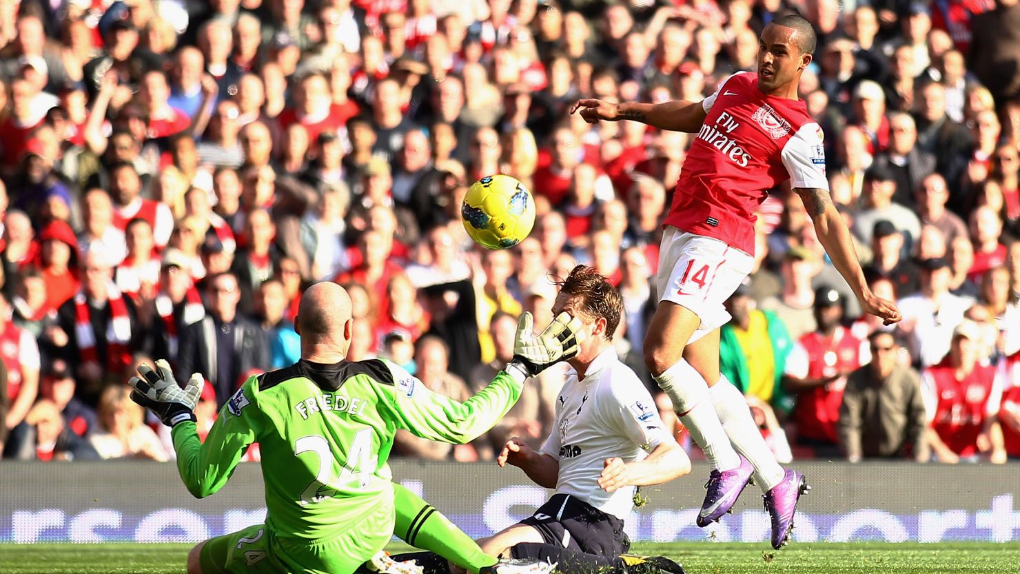 Theo Walcott scores the first of his two goals in Arsenal's 5-2 thrashing of Tottenham in the north London derby.