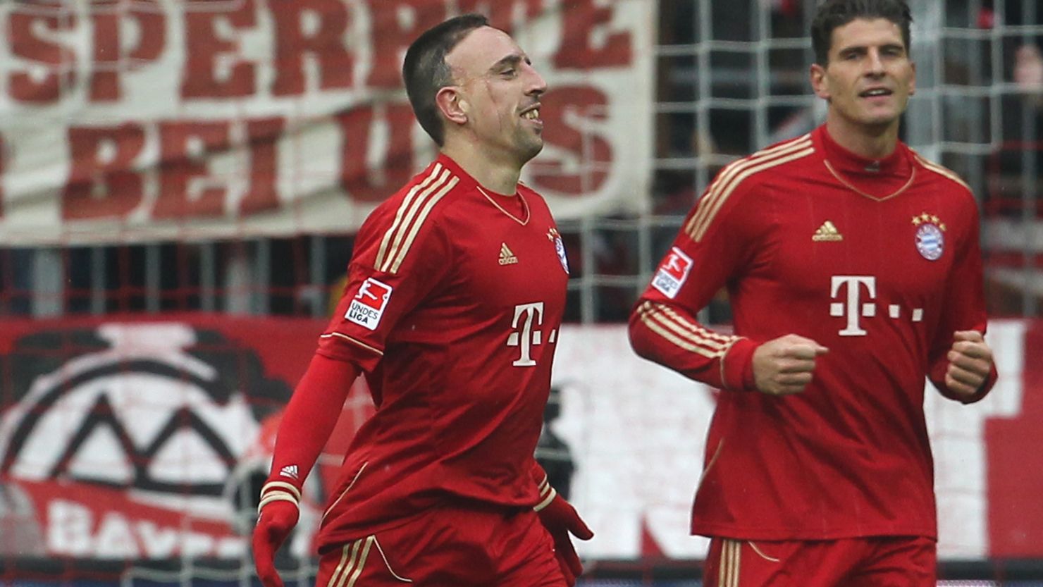 Franck Ribery celebrates with Bayern Munich teammate Mario Gomez after scoring his second goal against Schalke.