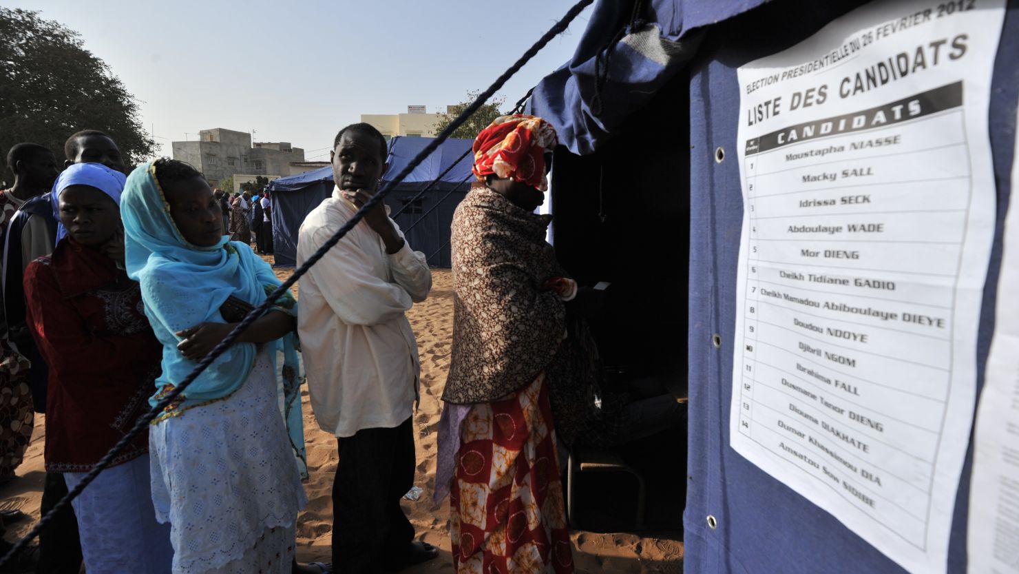 Senegalese voters line up to cast ballots Saunday in Dakar, Senegal. 