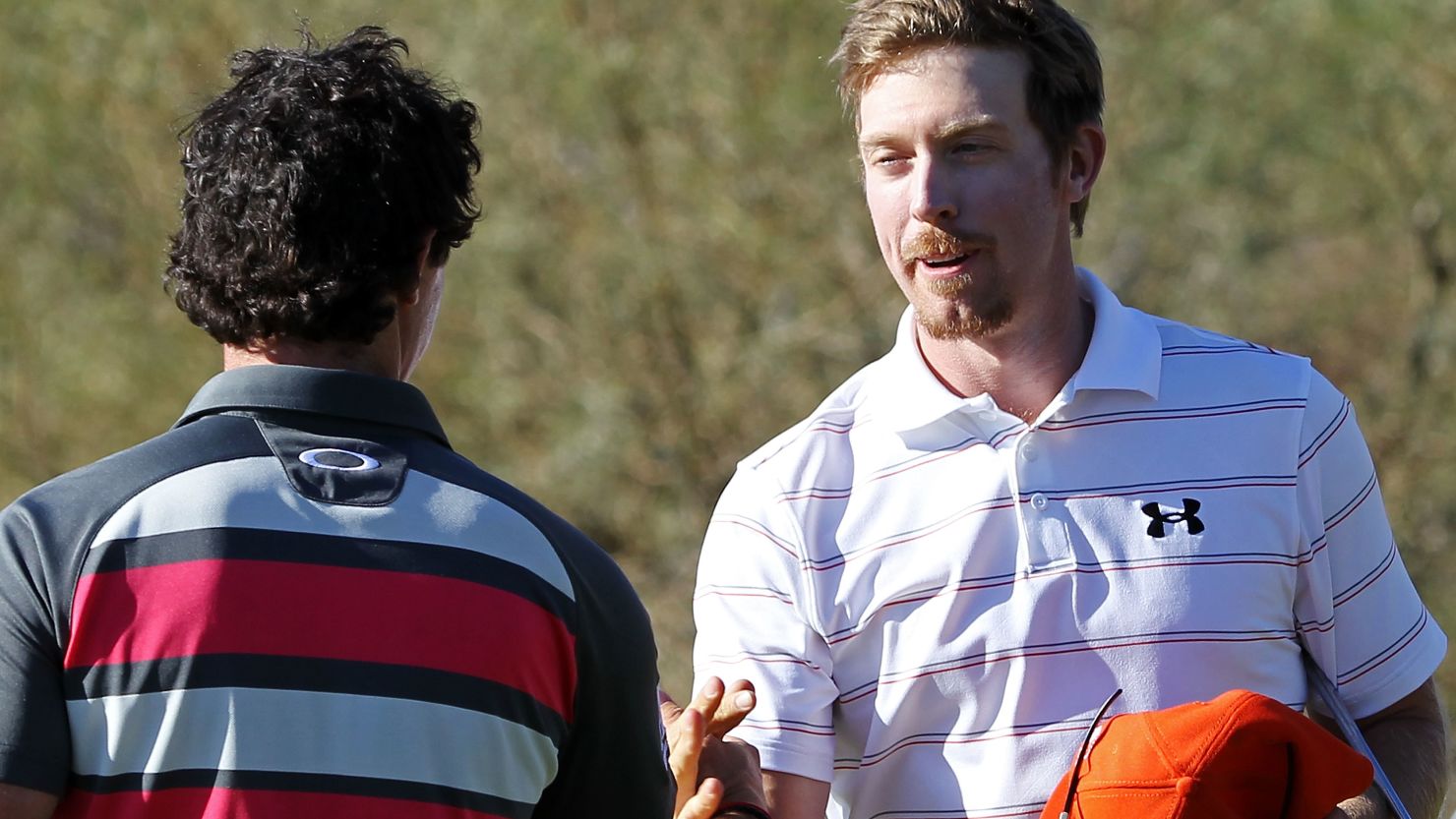 Hunter Mahan shakes hands with Rory McIlroy after beating him 2&1 in the final in Arizona.