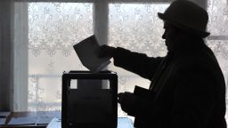 A woman casts her ballot at a polling station on February 26, 2012, during a pre-term voting for Russia's presidential elections.