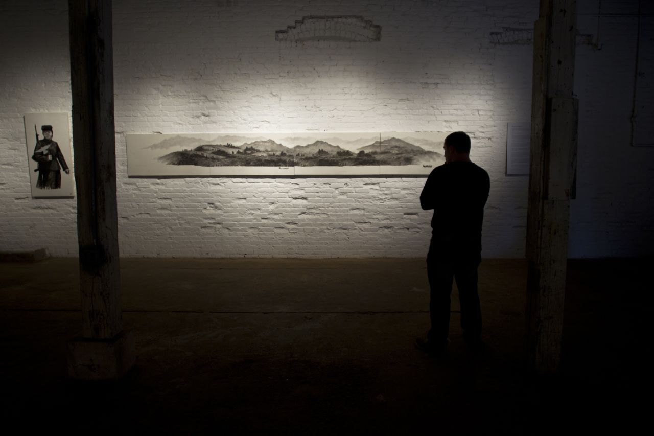 A work done in classic Tang Dynasty style, "Around the Tumen River" looks as if it could have been painted centuries ago. But an up-close view reveals the hard realities of life in North Korea. Farmers work without tractors, soldiers survive on fish they catch in a river, and people in hills scour for edible plants. 