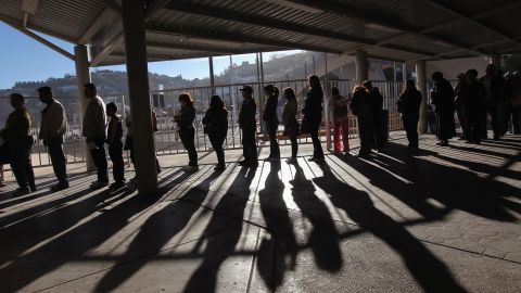 Hundreds of people wait to pass from Mexico into the U.S. at the border crossing  at Nogales, Arizona, on December 10, 2010.