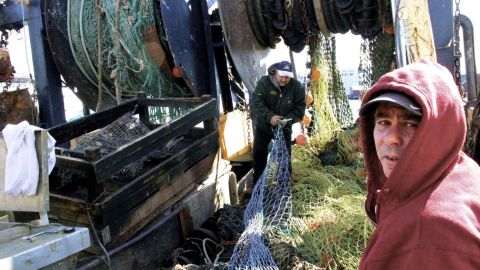 Fishermen work on docks in Gloucester, Massachusetts.