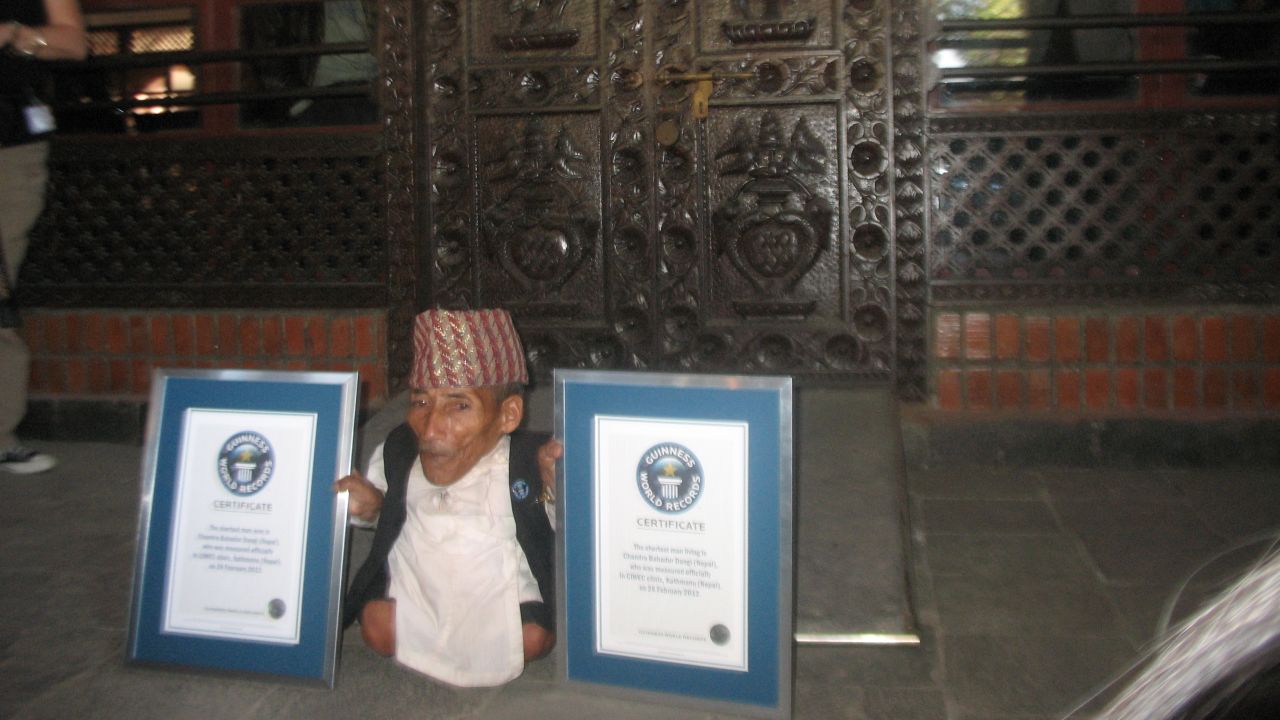 Chandra Bahadur Dangi displays two Guinness World Records certificates: for shortest man ever and shortest man living.