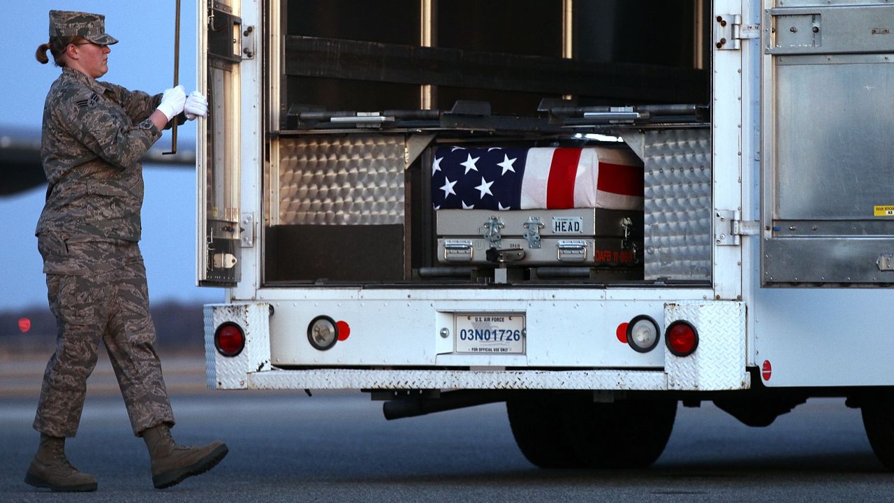Troops at Dover Air Force Base on Monday transfer the caskets of two U.S. officers who were killed in Afghanistan.