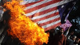 Activists of Majlis Ulma Nzamia Pakistan burn a US national flag during a protest in Lahore on February 27, 2012. 