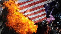 Activists of Majlis Ulma Nzamia Pakistan burn a US national flag during a protest in Lahore on February 27, 2012. 