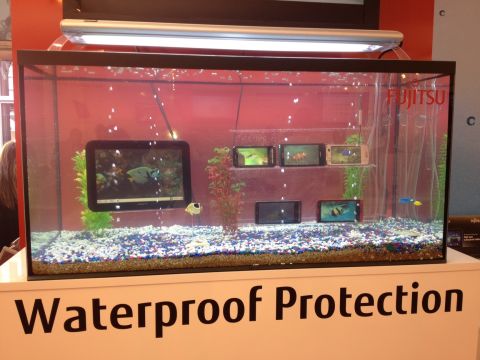 To prove their seaworthiness -- or just attract attention -- Fujitsu phones and tablets sit submerged in a fish tank at this tech trade show.