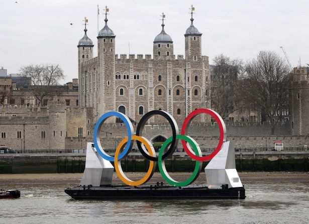 Giant Olympic rings are towed on the River Thames in front of the city's iconic Tower of London on February 28, 2012.